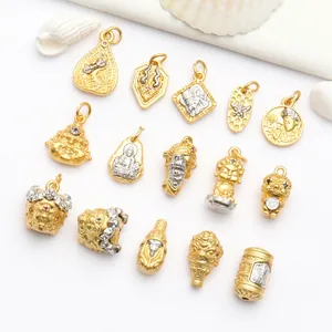 Macro view of ancient gold finish Buddhist pendants and beads for DIY jewelry crafting