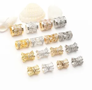 Close-up of 14K gold plated cubic zirconia spacer beads in various elegant shapes