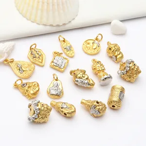 Detailed view of ancient gold style Buddhist charms and DIY jewelry accessories.