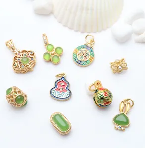 Collection of gold enamel charms and green stone pendants for DIY jewelry making.