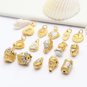 Detailed view of various ancient sand gold Buddhist charms and DIY jewelry beads