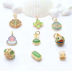 Detail of gold-plated enamel charms and green stone pendants for DIY jewelry