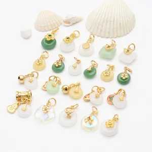 Detailed view of various antique gold chalcedony pendants with traditional motifs.