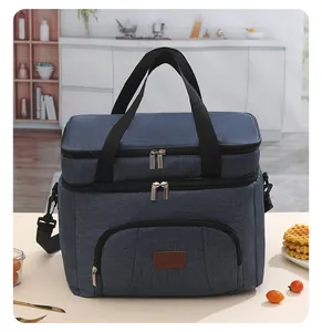 Detail view of a large navy blue insulated picnic bag featuring double zippers and strap