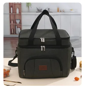 Large insulated picnic bag with double compartments and front zip pocket on table