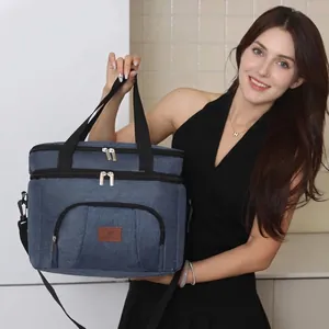 Large insulated blue lunch bag held by a model for outdoor picnic and commuting