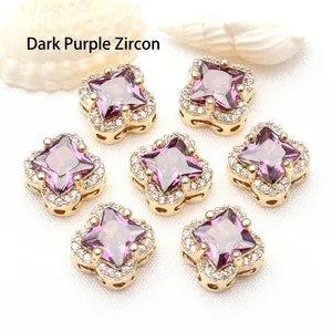 Close-up detail of 14K gold filled clover spacer beads with dark purple zircon stones