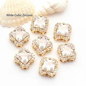 Macro view of 14K gold plated clover spacer beads with sparkling white cubic zirconia