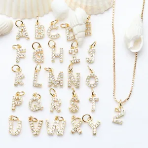 Detalle de colgantes de letras A-Z bañados en oro con circonitas brillantes