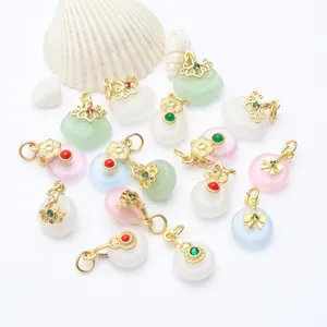 Detailed view of various ancient style gold and jade-like pendants for DIY jewelry making.