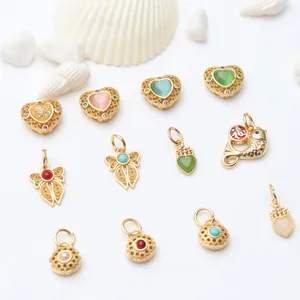 Detailed macro view of assorted DIY gold-plated jewelry charms with colorful enamel inlays