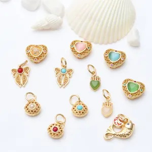 Collection of intricate gold-plated DIY jewelry pendants featuring colorful stones and enamel