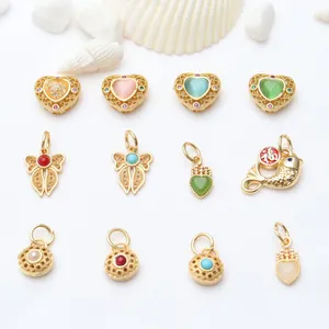 Detailed assortment of golden DIY jewelry charms featuring enamel heart and koi motifs