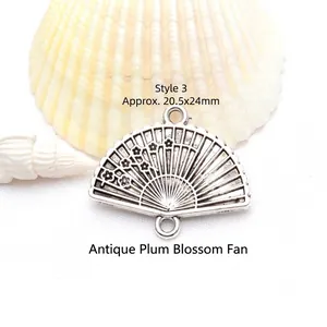 Detailed macro shot of an antique silver plum blossom fan pendant for jewelry DIY projects