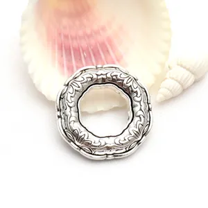 Close-up detail of retro Tibetan silver round ring accessory with embossed floral patterns
