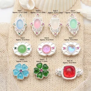 Close-up of 10 styles of silver-plated DIY beads with various shapes and colorful stones.