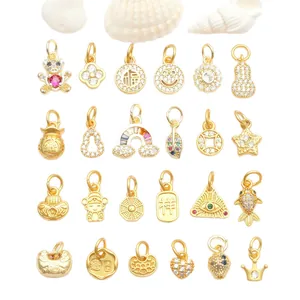 Close-up showing various micro-set zircon gold charms for DIY jewelry making