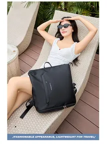 Black waterproof travel backpack with Player Travel logo shown in a lifestyle setting