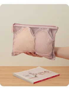 Close-up detail view of a pink mesh organizer bag for lingerie and travel essentials.