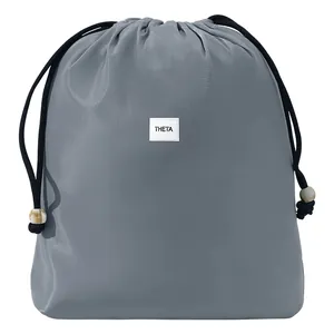 Grey waterproof drawstring storage bag for travel clothes and laundry organization.