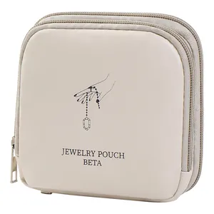 Elegant portable beige leather jewelry pouch with zipper and hand illustration print