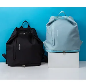Detailed view of black and light blue waterproof travel backpacks with shoe compartments