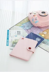 Pink PU leather passport holder travel wallet with airplane icon and travel map.