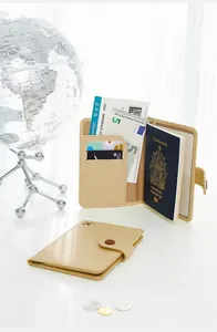 Detailed view of open PU leather passport holder with travel documents and cards