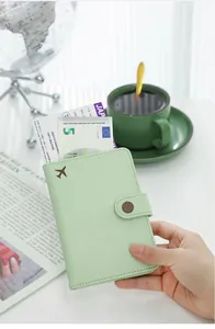 Close-up view of a mint green PU leather passport holder containing a boarding pass.