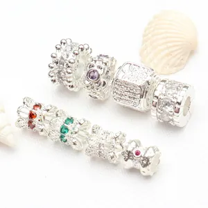 Close-up detail of silver-plated barrel beads with colorful micro-set CZ gemstones