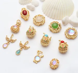 Detailed view of assorted gold-toned jewelry charms with colorful enamel details.