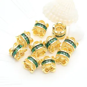 Close-up of 14K gold-plated spacer beads featuring emerald green micro-set zircons