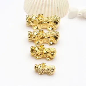 Macro view of 18k gold plated Pixiu beads in four different sizes for DIY jewelry