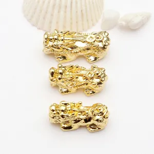 Detailed macro shot of three 18k gold-plated Pixiu charms for DIY jewelry making.