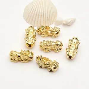 Detailed view of 6 golden PiXiu beads with 18k gold plating for DIY jewelry making