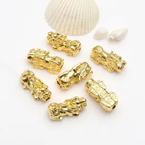 Detail view of 18k gold plated Pi Xiu beads used for DIY wealth jewelry making crafts