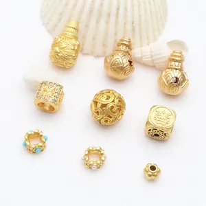 Macro detail of antique gold DIY beads and gourd charms for jewelry making kits
