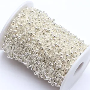 Detailed view of 3.5mm silver metal bead chain on white spool for jewelry making DIY