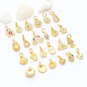 Macro detail view of various gold micro-pave zircon charms for DIY jewelry making