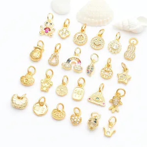 Selection of matte gold jewelry charms with micro-pave cubic zirconia for DIY necklaces