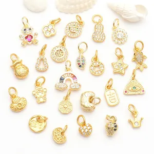 Detailed macro view of various gold-plated CZ jewelry charms for DIY accessory making