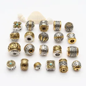 Collection of Tibetan style antique gold and silver alloy beads with intricate patterns