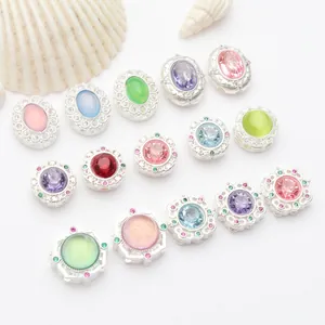 Macro view of matte silver plated jewelry spacer beads with colorful gemstone inlays