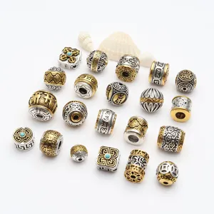 Detail view of various Tibetan style alloy beads with gold and silver finishes