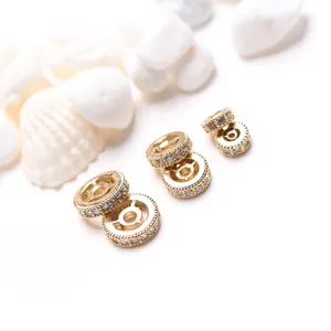 Macro detail of 14K gold-plated spacer beads with brilliant micro-set cubic zirconia
