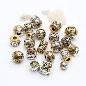 Detailed view of Tibetan-style gold and silver alloy beads with ethnic patterns