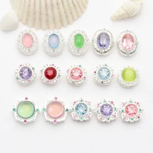 Detailed view of matte silver spacer beads with various colorful inset stones for DIY jewelry