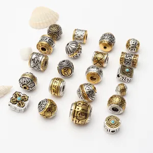 Detailed view of Tibetan-style antique gold and silver alloy spacer beads with intricate patterns