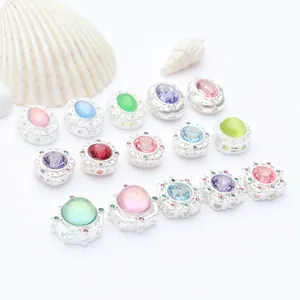Detailed macro view of silver-plated beads set with colorful gemstones for DIY jewelry.
