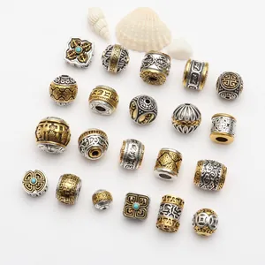 Close-up of Tibetan-style alloy spacer beads with antique gold and silver finish
